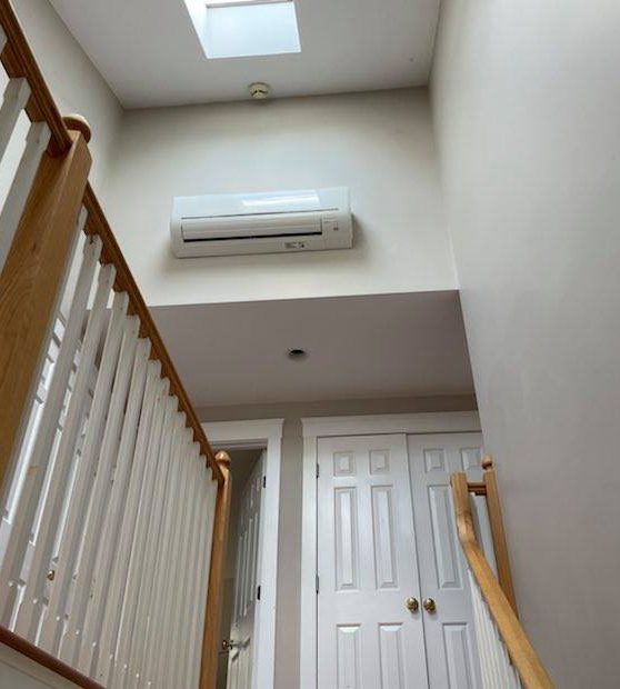 Ductless mini-split head installed above a stairwell by Peabody Huggins